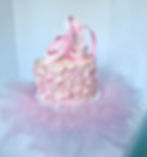 Pink ballerina cake with tulle, pink ballet slippers on top & covered in soft pink pedals.