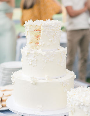 Pure white 3-tier wedding cake with white floral petals